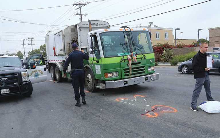 Man struck by garbage truck