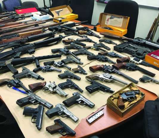 Two arrested with large cache of weapons