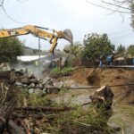 Image for display with article titled Flooded creek tears away chunk of Soquel’s Main Street