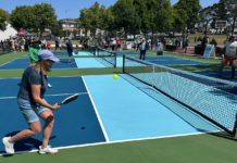 People playing pickleball outdoors on a freshly built court