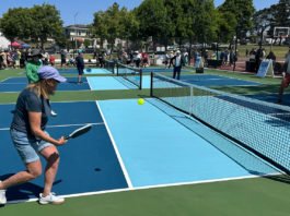People playing pickleball outdoors on a freshly built court