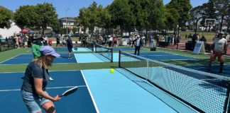 People playing pickleball outdoors on a freshly built court