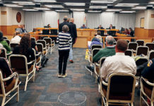 People waiting to talk at a government meeting