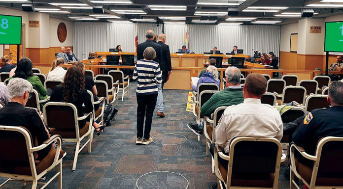 People waiting to talk at a government meeting