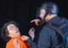 Two performers acting as prisoner and guard