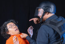 Two performers acting as prisoner and guard