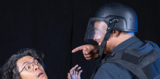Two performers acting as prisoner and guard