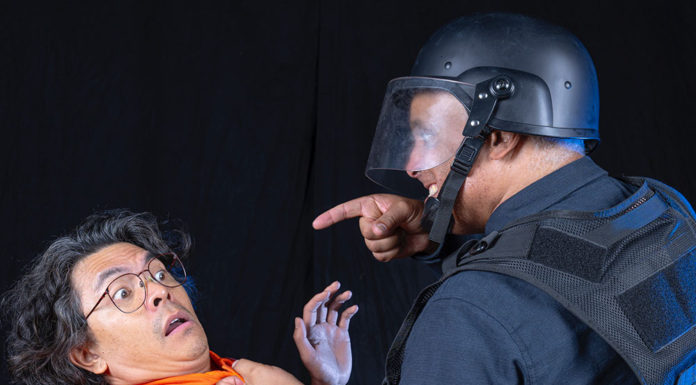 Two performers acting as prisoner and guard