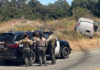sheriffs look on at van that skidded off the road