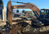 Work crews dig the foundation for a new apartment building on Main Street.
