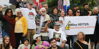 About 50 people gather in front of Driscoll’s headquarters on Westridge Drive in Watsonville to protest pesticide use in area agricultural fields.