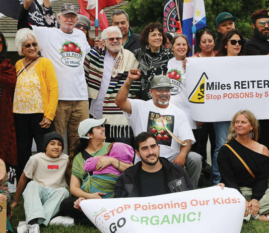 About 50 people gather in front of Driscoll’s headquarters on Westridge Drive in Watsonville to protest pesticide use in area agricultural fields.