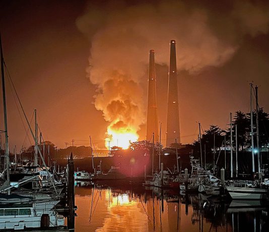 Report finds no long-term health risk from Moss Landing battery fire The fire at Moss Landing reflects off the waters of Moss Landing Harbor. (photo by Liza Azil)
