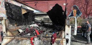 Chucky De Luna inspects the damage where a fire demolished a Ford F550 pickup at the rear loading area of Habitat for Humanity's Restore late Monday night on the 500 block of Main Street.