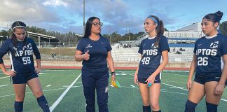 Gina Castañeda (second from left) works with the girls varsity soccer team at Aptos High School