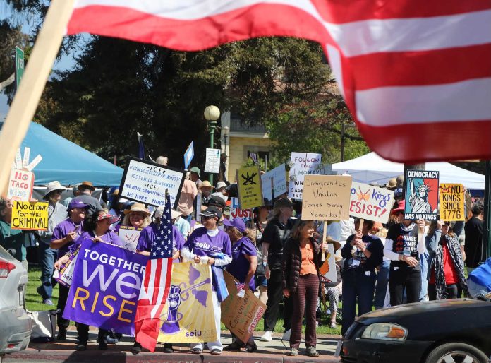 Around 600 people join the No Kings protest against President Trump Saturday in Watsonville Plaza along with thousands of others around the nation. From people in strollers to those in wheelchairs and on walkers, people waved signs and chanted 