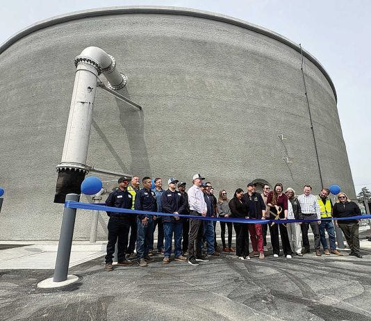 Watsonville Mayor Kristal Salcido (center with scissors) cuts the ribbon for the completion of a 2 million gallon water storage tank Monday on Burchell Avenue while joined by a cast of city officials.
