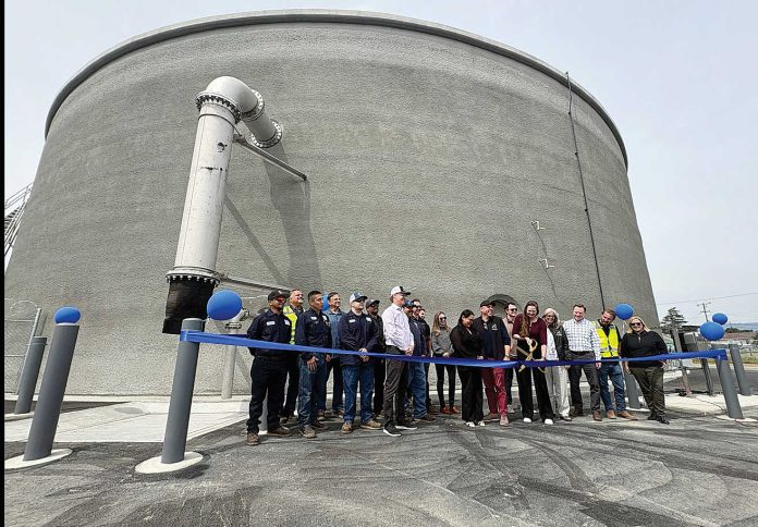 Watsonville Mayor Kristal Salcido (center with scissors) cuts the ribbon for the completion of a 2 million gallon water storage tank Monday on Burchell Avenue while joined by a cast of city officials.