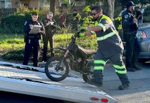 A tow operator lifts one of two electric dirt bikes onto a flatbed truck after being stopped by Watsonville Police