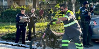A tow operator lifts one of two electric dirt bikes onto a flatbed truck after being stopped by Watsonville Police
