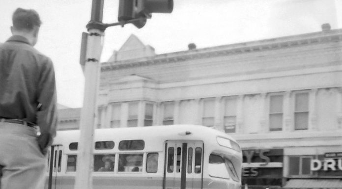 A city bus rolls along Main Street into the Watsonville Transit Square on March 23, 1954.