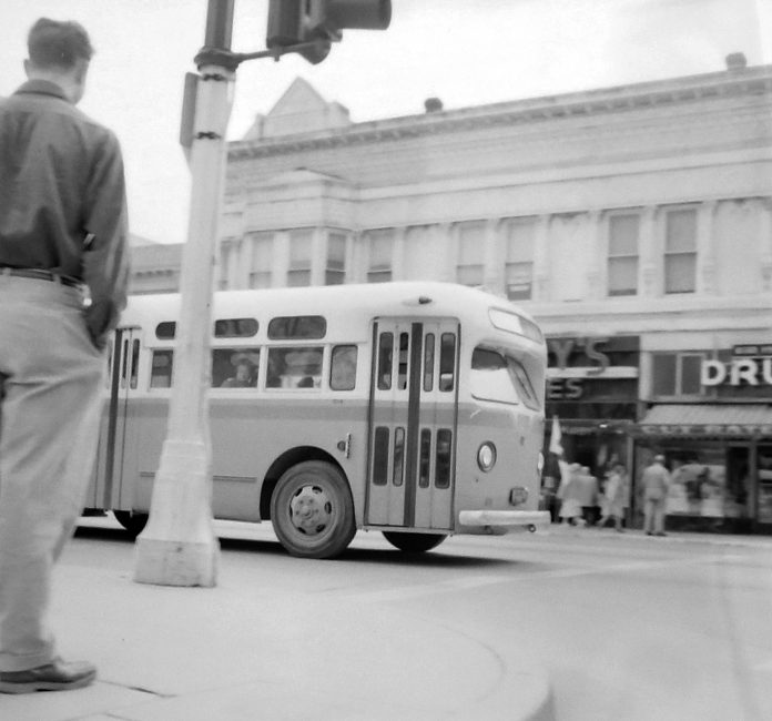 A city bus rolls along Main Street into the Watsonville Transit Square on March 23, 1954.
