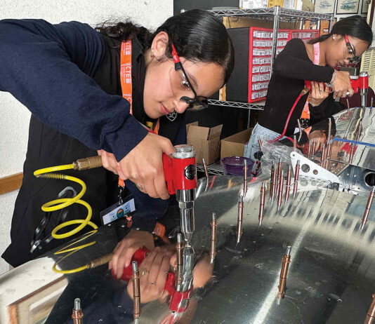 Pajaro Valley High students taking flight RIVETING Valeria Melgoza-Ortiz inserts rivets into the tail section of an Van’s RV-12 two-seat airplane.