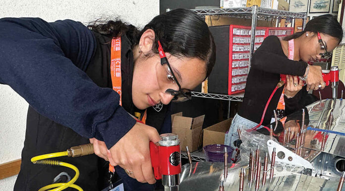 RIVETING Valeria Melgoza-Ortiz inserts rivets into the tail section of an Van’s RV-12 two-seat airplane.