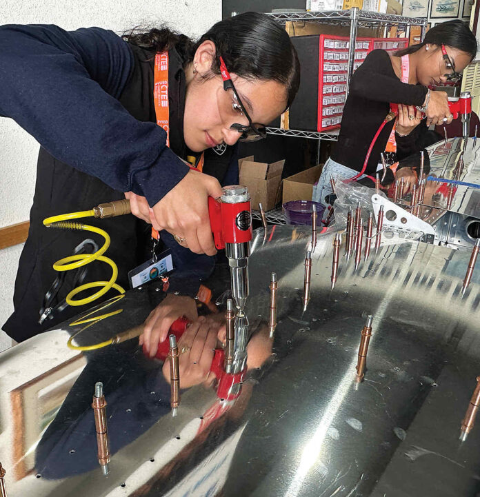 aviation kids 1 RIVETING Valeria Melgoza-Ortiz inserts rivets into the tail section of an Van’s RV-12 two-seat airplane.