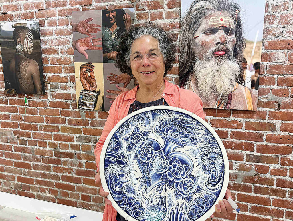 Roberta Valdez shows a ceramic work by Britton McFetridge. Valdez is the curator of the current exhibit at PV Arts in Watsonville. (Tarmo Hannula/The Pajaronian)