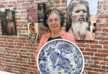 Exhibit on body art comes to PV Arts Roberta Valdez shows a ceramic work by Britton McFetridge. Valdez is the curator of the current exhibit at PV Arts in Watsonville. (Tarmo Hannula/The Pajaronian)
