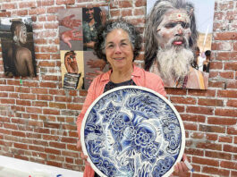 Roberta Valdez shows a ceramic work by Britton McFetridge. Valdez is the curator of the current exhibit at PV Arts in Watsonville. (Tarmo Hannula/The Pajaronian)