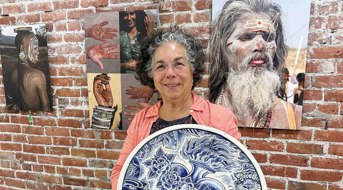 Exhibit on body art comes to PV Arts Roberta Valdez shows a ceramic work by Britton McFetridge. Valdez is the curator of the current exhibit at PV Arts in Watsonville. (Tarmo Hannula/The Pajaronian)