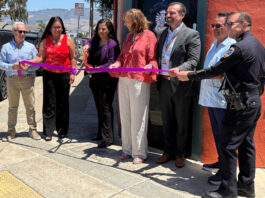 Santa Cruz County District Attorney Jeff Rosell, left, joins Aztecas Youth Soccer Academy founder Gina Castañeda, Chief Probation Officer Sandra Mendez, 1440 Multiversity co-creator Joanie Kriens, Santa Cruz County Superintendent of Schools Faris Sabbah, Ramon Gomez from Santa Cruz County Supervisor Felipe Hernandez’s office and Watsonville Police Chief Brian Shab in a ribbon-cutting ceremony at Aztecas new clubhouse.