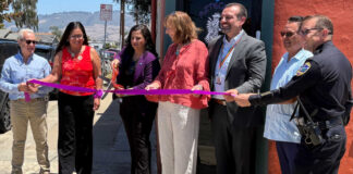 Santa Cruz County District Attorney Jeff Rosell, left, joins Aztecas Youth Soccer Academy founder Gina Castañeda, Chief Probation Officer Sandra Mendez, 1440 Multiversity co-creator Joanie Kriens, Santa Cruz County Superintendent of Schools Faris Sabbah, Ramon Gomez from Santa Cruz County Supervisor Felipe Hernandez’s office and Watsonville Police Chief Brian Shab in a ribbon-cutting ceremony at Aztecas new clubhouse.