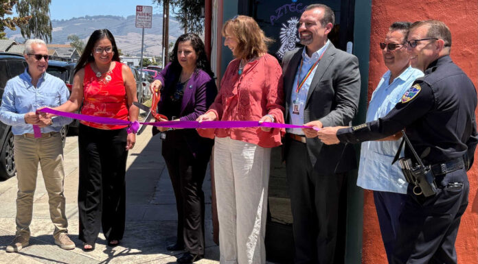 Santa Cruz County District Attorney Jeff Rosell, left, joins Aztecas Youth Soccer Academy founder Gina Castañeda, Chief Probation Officer Sandra Mendez, 1440 Multiversity co-creator Joanie Kriens, Santa Cruz County Superintendent of Schools Faris Sabbah, Ramon Gomez from Santa Cruz County Supervisor Felipe Hernandez’s office and Watsonville Police Chief Brian Shab in a ribbon-cutting ceremony at Aztecas new clubhouse.