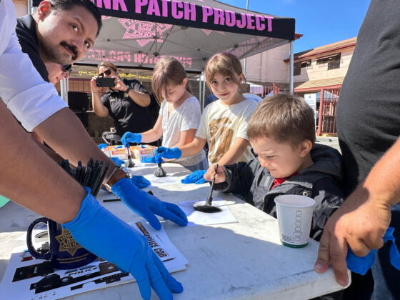 COMMUNITY ENGAGEMENT Salvador Gonzalez-Fernandez, 3, tries his skills at lifting fingerprints at a table set up by Watsonville Police Tuesday in downtown Watsonville during the annual National Night Out.