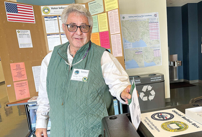 Joseph Eaton drops his ballot in the box at the City of Watsonville Civic Plaza voting station on June 2. (Tarmo Hannula/Pajaronian file)