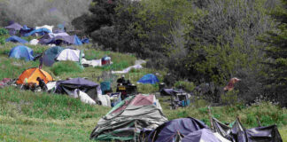 In 2024, a string of tents and makeshift shelters lined the Pajaro River levee in Watsonville. (Tarmo Hannula/Pajaronian file)