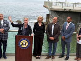 Ted Balestreri, CEO and Chairman of the Cannery Row Company, left, joins Monterey County Supervisor Supervisor Kate Daniels, at podium, along with Monterey Bay Aquarium CEO Jenny Gray, Rep. Jimmy Panetta, Monterey Mayor Tyller Williamson and Save Our Shores Executive Director Katie Thompson. (Todd Guild/The Pajaronian)