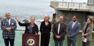 Ted Balestreri, CEO and Chairman of the Cannery Row Company, left, joins Monterey County Supervisor Supervisor Kate Daniels, at podium, along with Monterey Bay Aquarium CEO Jenny Gray, Rep. Jimmy Panetta, Monterey Mayor Tyller Williamson and Save Our Shores Executive Director Katie Thompson. (Todd Guild/The Pajaronian)