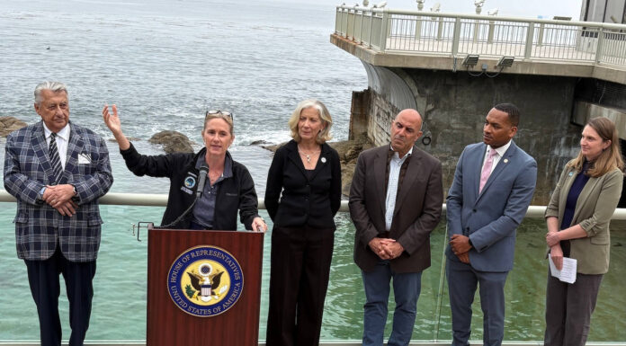 Ted Balestreri, CEO and Chairman of the Cannery Row Company, left, joins Monterey County Supervisor Supervisor Kate Daniels, at podium, along with Monterey Bay Aquarium CEO Jenny Gray, Rep. Jimmy Panetta, Monterey Mayor Tyller Williamson and Save Our Shores Executive Director Katie Thompson. (Todd Guild/The Pajaronian)