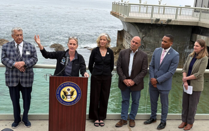 Ted Balestreri, CEO and Chairman of the Cannery Row Company, left, joins Monterey County Supervisor Supervisor Kate Daniels, at podium, along with Monterey Bay Aquarium CEO Jenny Gray, Rep. Jimmy Panetta, Monterey Mayor Tyller Williamson and Save Our Shores Executive Director Katie Thompson. (Todd Guild/The Pajaronian)