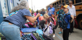 Stuff the Bus volunteers pack 2,500 backpacks for students