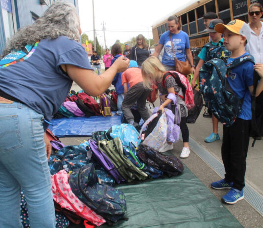 Stuff the Bus volunteers pack 2,500 backpacks for students